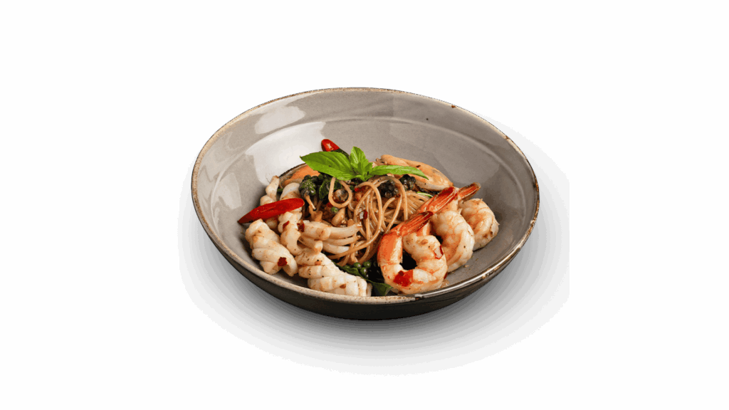 SPICY MIXED SEAFOOD at DAVIN CAFE restaurant Bangkok featuring spicy seafood pasta with shrimp, squid and fresh herbs, a premium Thai fusion seafood dish in a top Bangkok restaurant