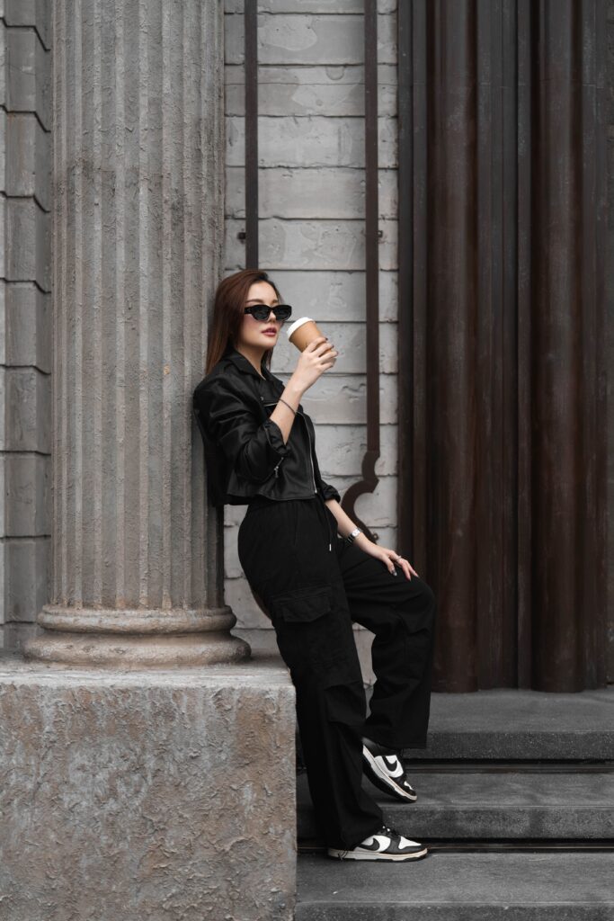 Stylish customer enjoying coffee outside DAVIN CAFE, a visually iconic cafe near me in Bangkok, featuring luxury industrial architecture and an urban lifestyle atmosphere ideal for coffee lovers and photo enthusiasts