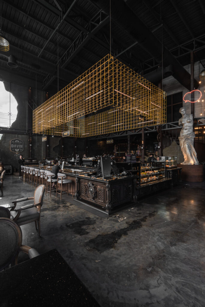 Spacious luxury industrial interior at DAVIN CAFE, a standout cafe near me in Bangkok, featuring high ceilings, an architectural coffee bar, and an upscale atmosphere designed for coffee lovers, meetings, and lifestyle experiences