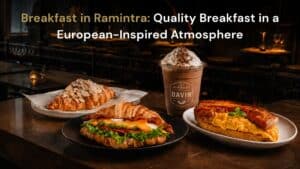 Hero image for Davin Cafe’s breakfast in Ramintra article, featuring croissant sandwiches, almond croissant, salmon and egg breakfast, and iced coffee in a European-inspired cafe setting for a refined morning dining experience.