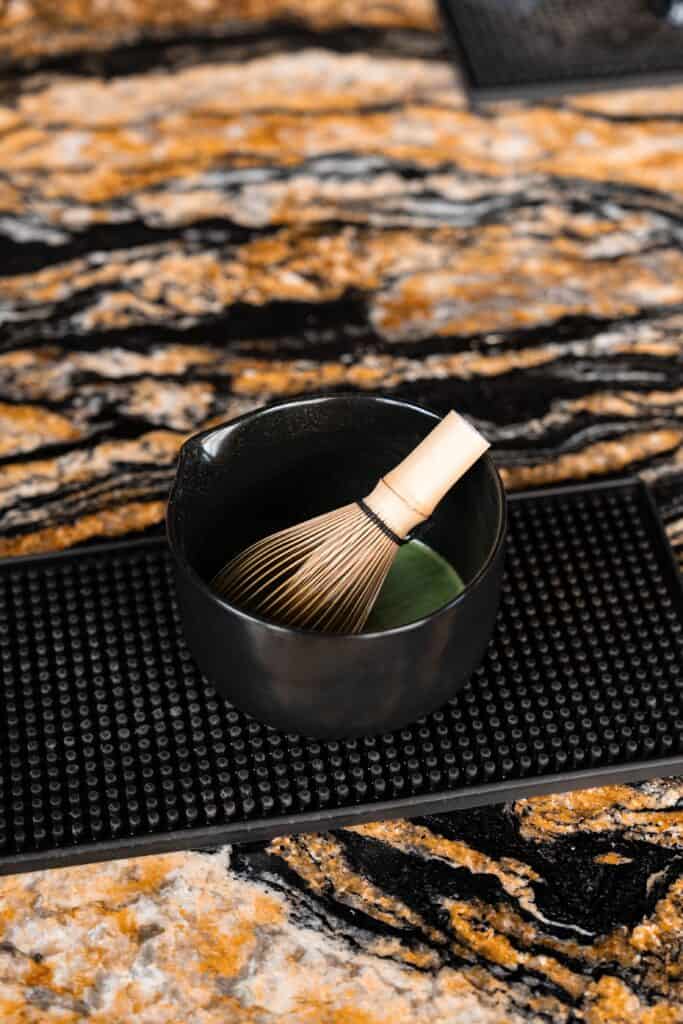 Premium Matcha Latte preparation at DAVIN CAFE Bangkok using ceremonial-grade matcha and a traditional bamboo whisk to create a rich, smooth, authentic Japanese matcha experience.